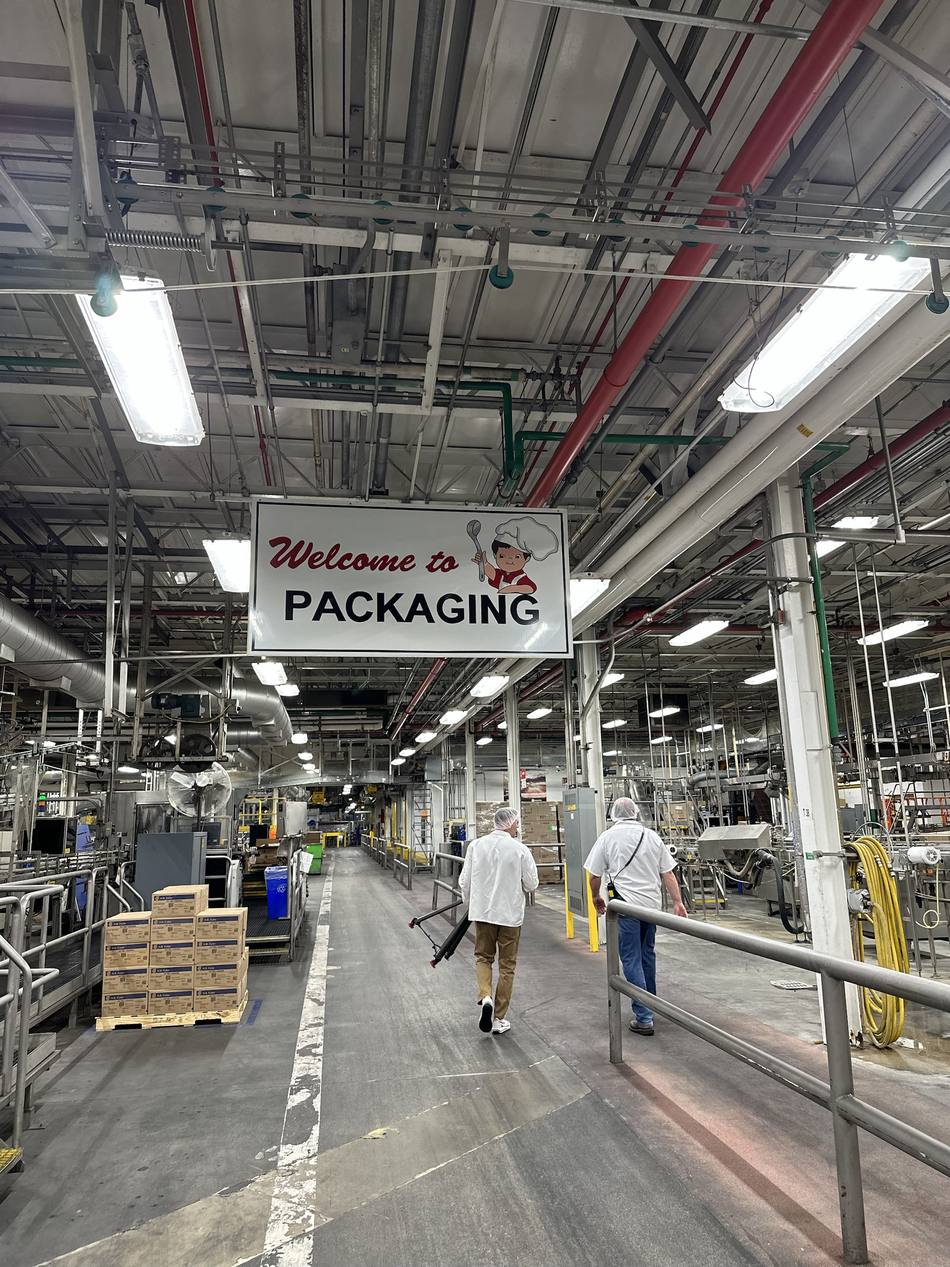 Crew walking through the packaging area of the Campbell's plant during production of the WSJ film.