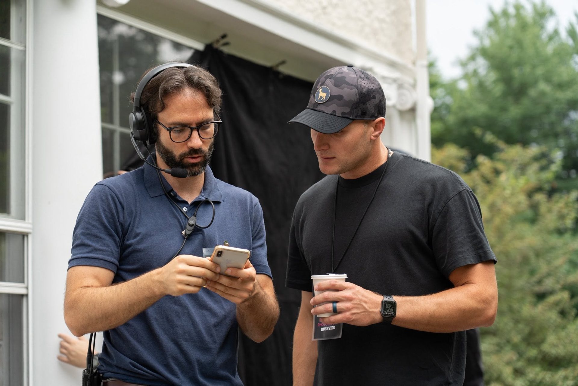 Collaborators review a phone on an Applebee’s production.