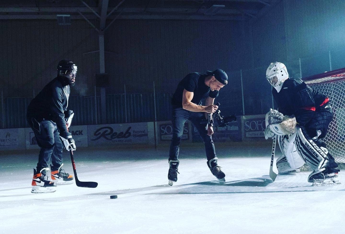 A camera operator films hockey players for a Nike spec ad.